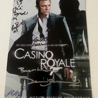 Casino Royale photo signed by David Arnold, Judi Dench, Christina Cole, Tom Chadbon, Greg Bennett and Joseph Millson