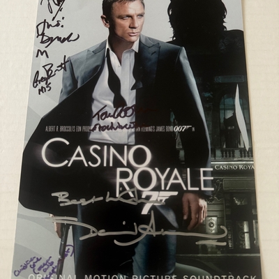 Casino Royale photo signed by David Arnold, Judi Dench, Christina Cole, Tom Chadbon, Greg Bennett and Joseph Millson