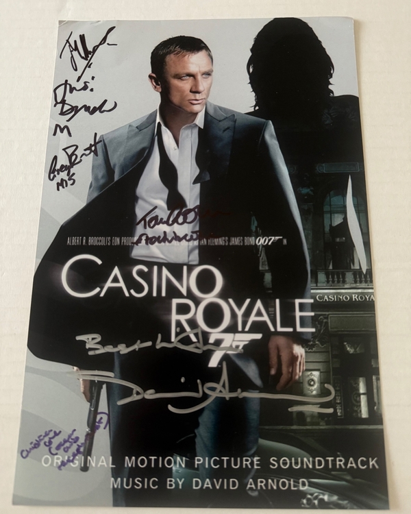 Casino Royale photo signed by David Arnold, Judi Dench, Christina Cole, Tom Chadbon, Greg Bennett and Joseph Millson