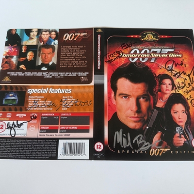 Tomorrow Never Dies DVD sleeve signed by Judi Dench, Hugh Bonneville, Tracey Eddon (stunts) and Abbi Collins (stunts). Cover only