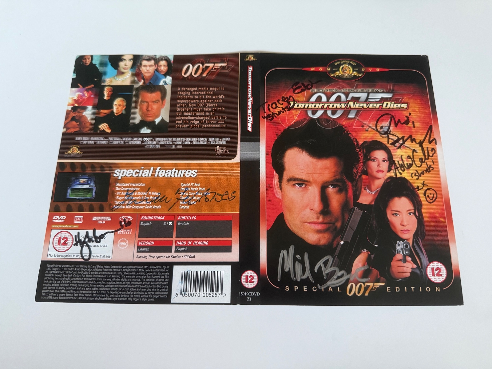 Tomorrow Never Dies DVD sleeve signed by Judi Dench, Hugh Bonneville, Tracey Eddon (stunts) and Abbi Collins (stunts). Cover only