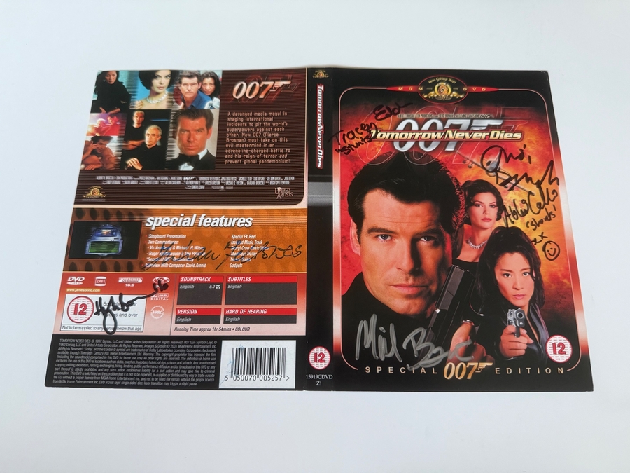 Tomorrow Never Dies DVD sleeve signed by Judi Dench, Hugh Bonneville, Tracey Eddon (stunts) and Abbi Collins (stunts). Cover only