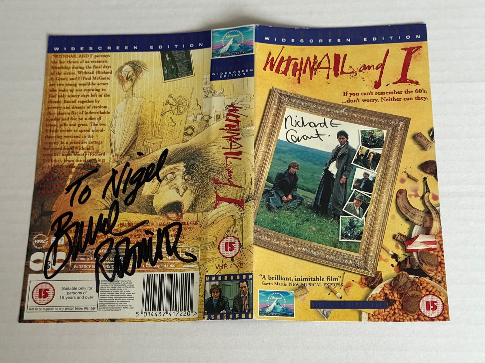Withnail and I VHS cover signed by Bruce Robinson (Writer/Director) and Richard E Grant. Dedicated to Nigel.