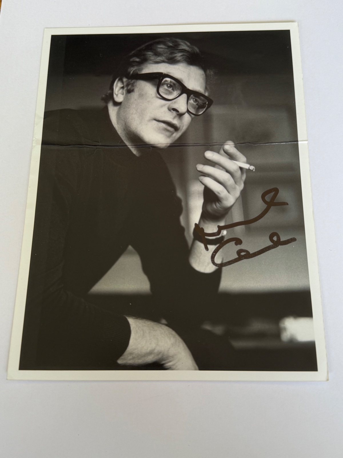 Michael Caine - signed photo. Creased.