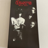 The Doors Box set. Signed on booklet by Ray Manzarek. Signed on rear of “The future ain’t what it used to be” cd by Ray Manzarek and also to rear of another cd by Ray Manzarek (Smudged)