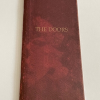 The Doors Box set. Signed on booklet by Ray Manzarek. Signed on rear of “The future ain’t what it used to be” cd by Ray Manzarek and also to rear of another cd by Ray Manzarek (Smudged)