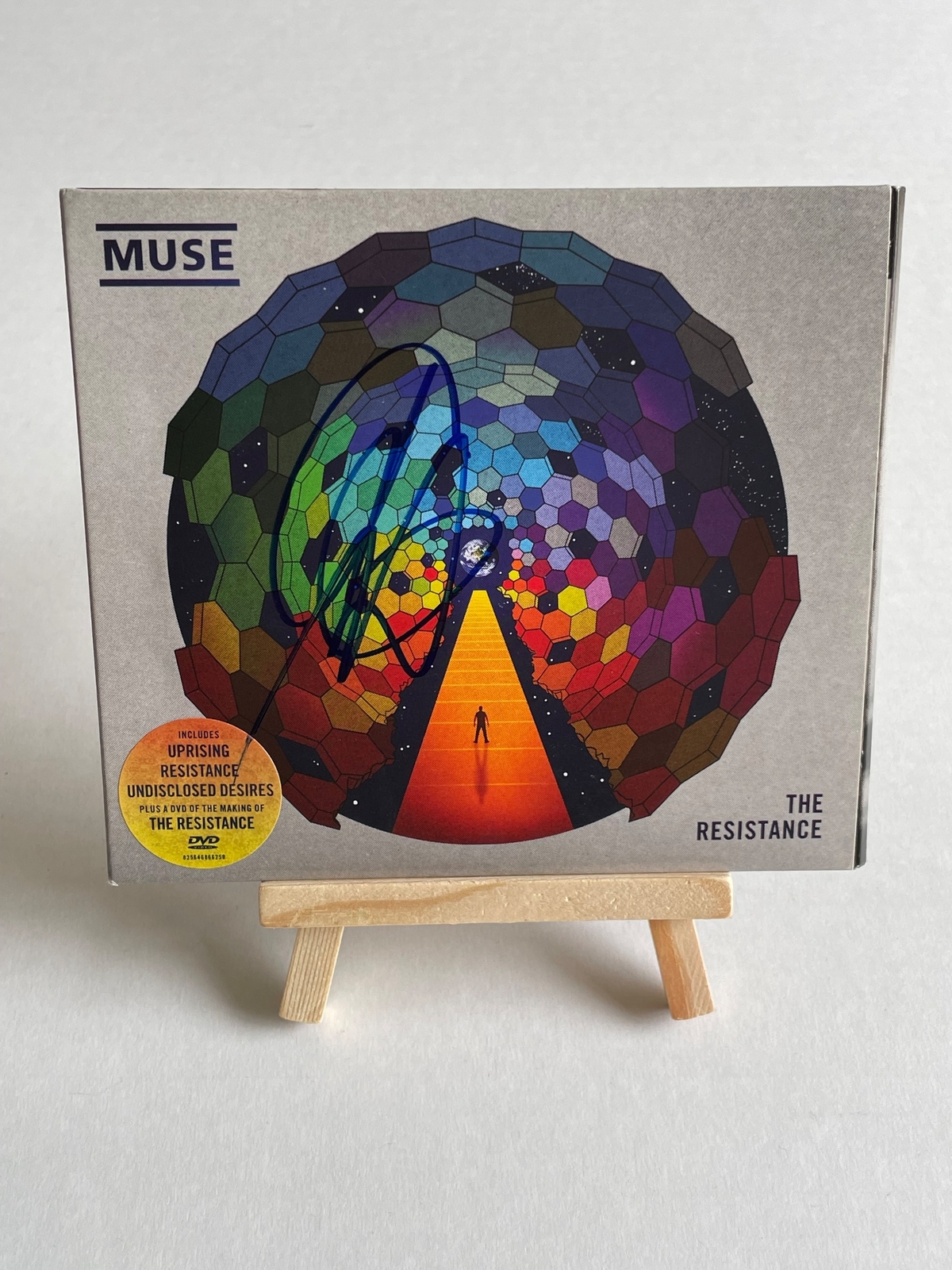 Muse - The Resistance CD. Signed by Chris Wolstenholme on front cover and Dominic Howard on card