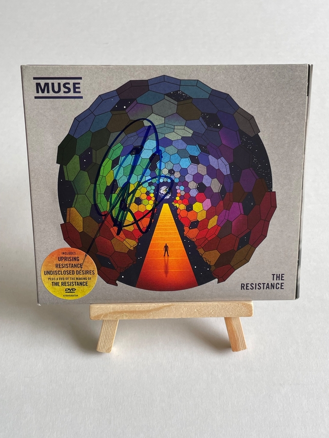 Muse - The Resistance CD. Signed by Chris Wolstenholme on front cover and Dominic Howard on card