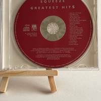 Squeeze - Greatest Hits CD. Signed on front by Paul Carrack, Jools Holland. On the rear, Chris Difford? Plus possibly one other