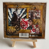 Elvis Costello and the attractions - All This Useless Beauty. Signed by Elvis Costello to front cover and Steve Nieve on rear page