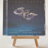 Electric Light Orchestra - Light Years. Signed on front of book cover by: Bev Bevan. Signed on rear page by: Kelly Groucutt, Louis Clark and Mik Kaminski