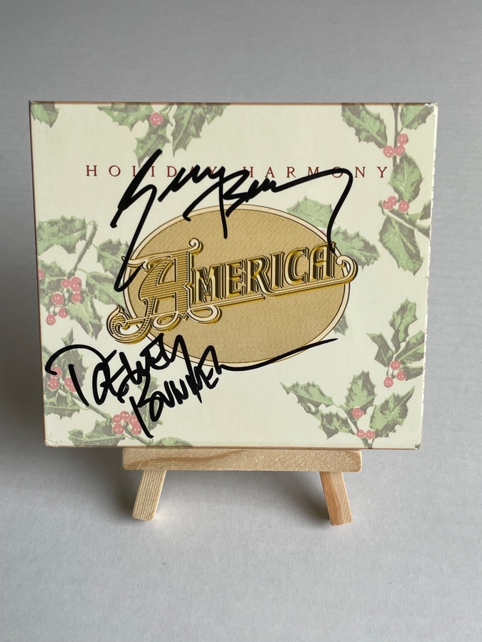 America - Holiday Harmony CD. Signed by Dewey Bunnell and Gerry Beckley