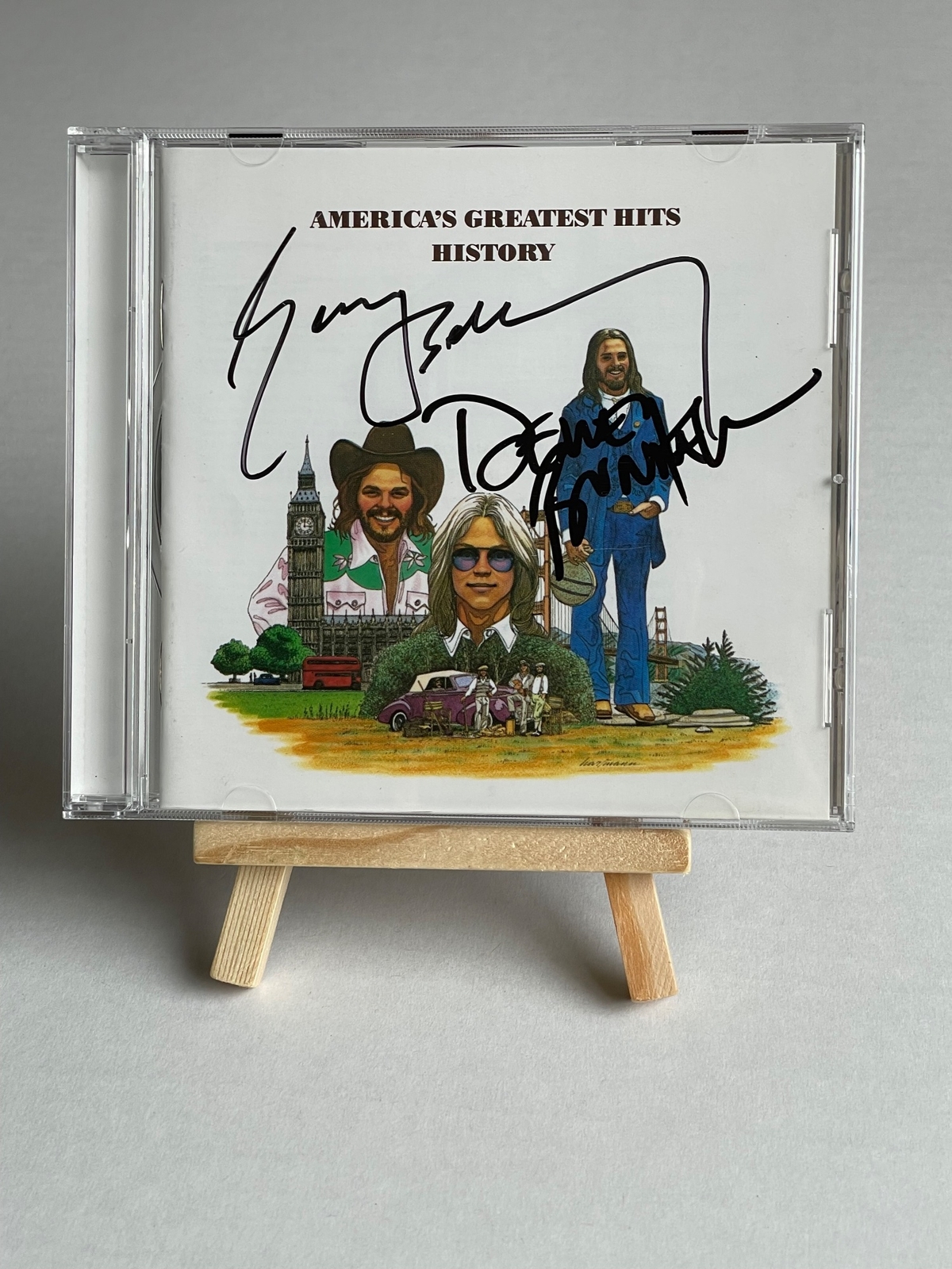 America - America’s Greatest Hits History CD. Signed by Dewey Bunnell and Gerry Beckley
