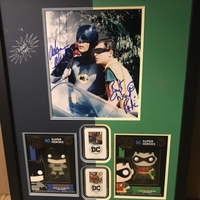 Burt ward & Adam West joint signed picture with2 funko badges and 2 Batman themed 1st stamps. Professionally mounted and framed signed item