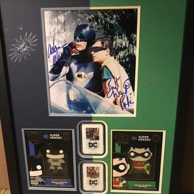 Burt ward & Adam West joint signed picture with2 funko badges and 2 Batman themed 1st stamps. Professionally mounted and framed signed item