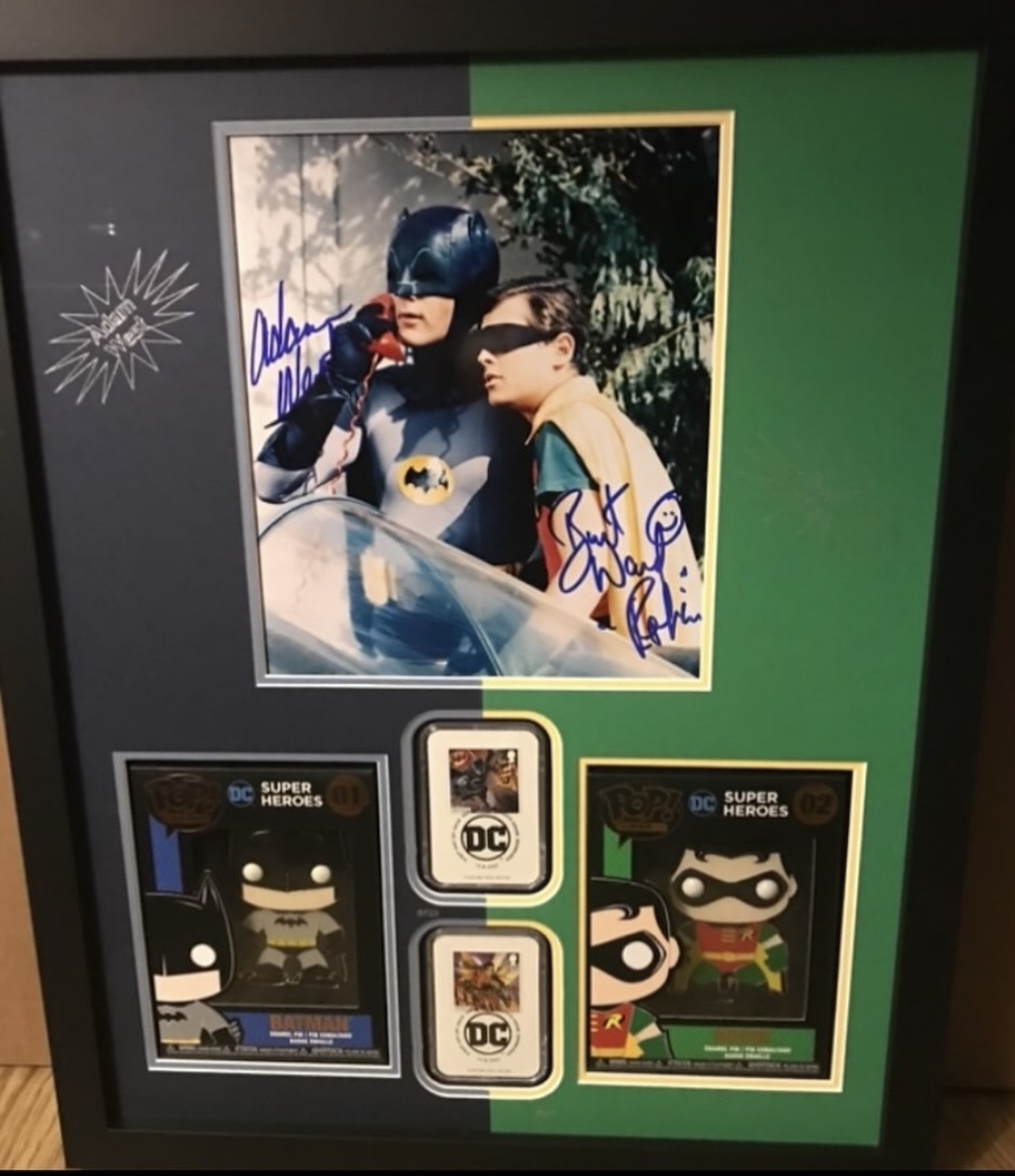 Burt ward & Adam West joint signed picture with2 funko badges and 2 Batman themed 1st stamps. Professionally mounted and framed signed item